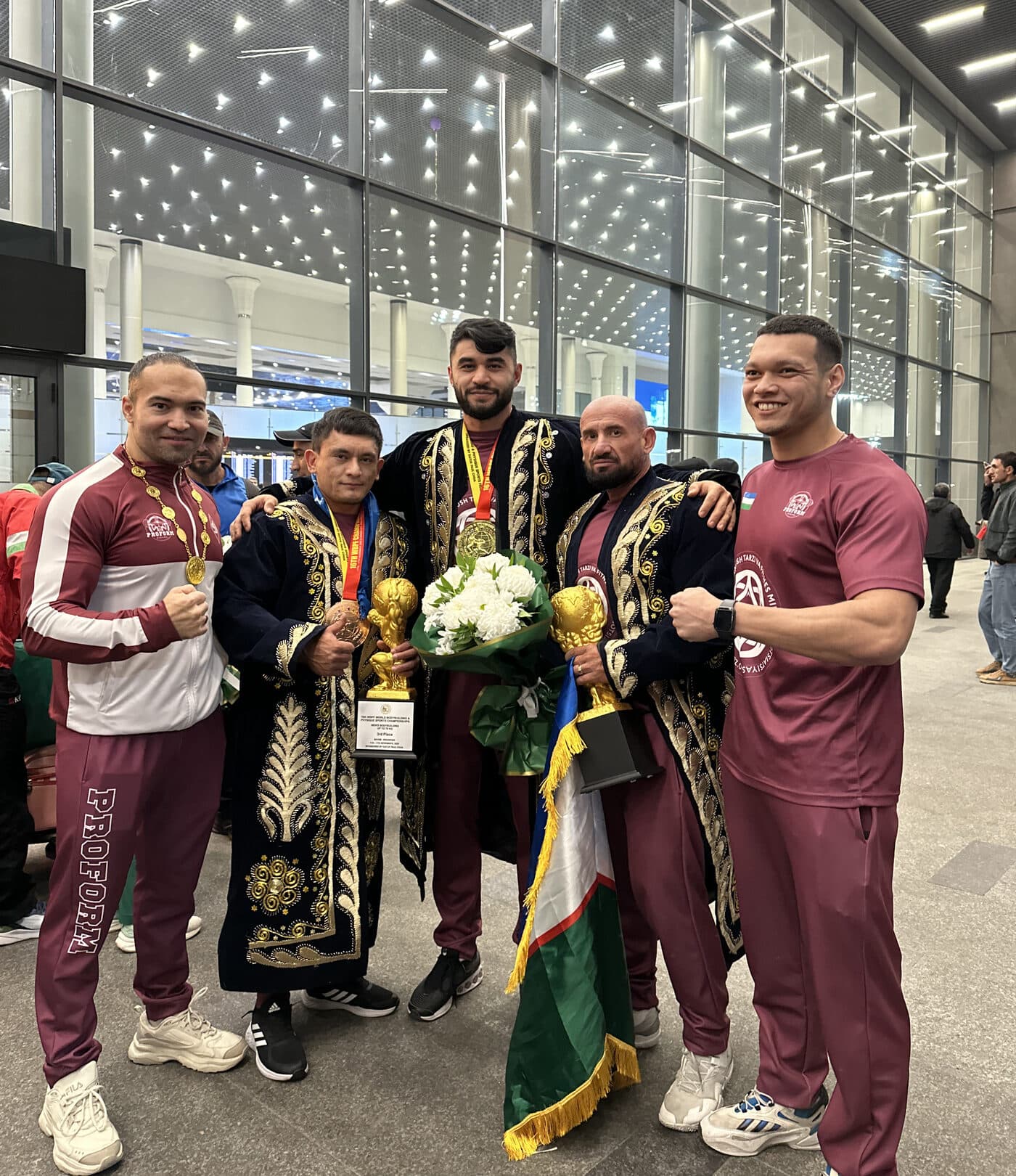 Uzbekistan's team returning as WBPF medalists in national dress and PROFORM colors